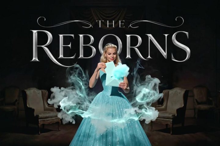 Poster-style image of a woman in a turquoise ball gown opening a letter on a smoky, dark stage with the title 'The Reborns' above her.