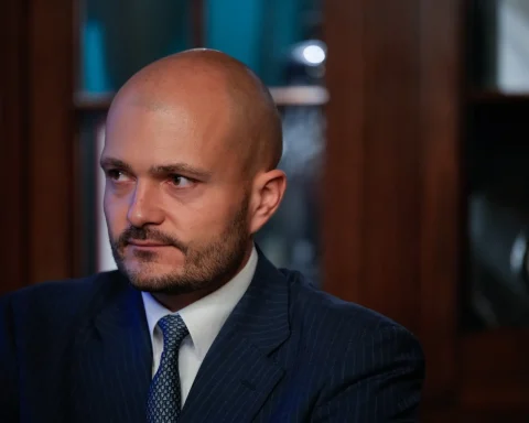 Czech billionaire Michal Strnad in a pinstripe suit looking to the side