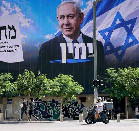Large Likud campaign billboard featuring Benjamin Netanyahu above a street