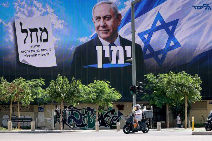 Large Likud campaign billboard featuring Benjamin Netanyahu above a street