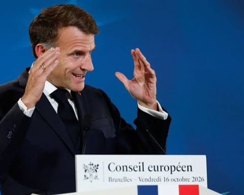 French President Emmanuel Macron gestures while speaking at a European Council press conference