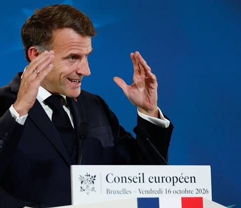 French President Emmanuel Macron gestures while speaking at a European Council press conference