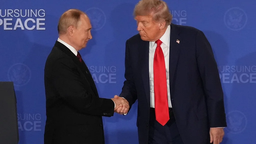 US President Trump shakes hands with Russian President Putin at a peace summit
