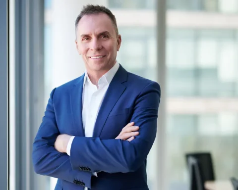 Wizz Air CEO Jozsef Varadi standing with arms crossed in an office